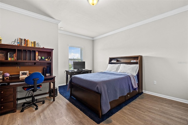 bedroom with hardwood / wood-style floors and crown molding