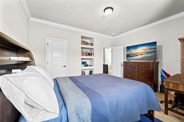 bedroom featuring light hardwood / wood-style floors and crown molding