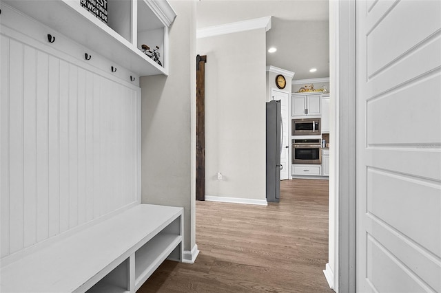 mudroom with dark hardwood / wood-style flooring and crown molding