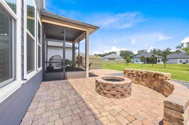 view of patio with a fire pit and a sunroom