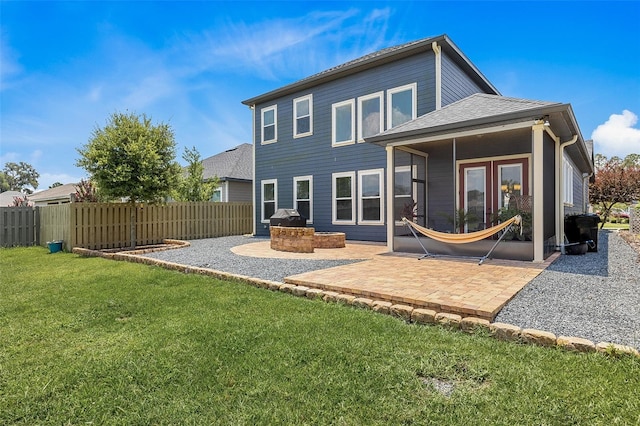 rear view of property featuring a lawn and a patio