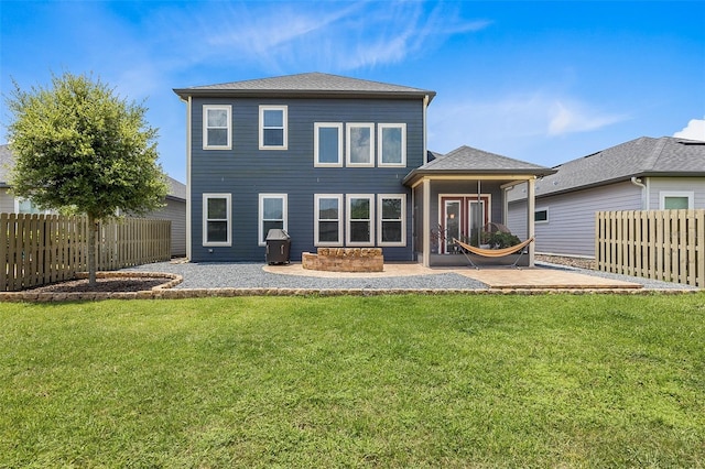 rear view of property with a yard and a patio