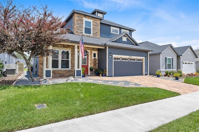 craftsman house featuring a garage and a front lawn