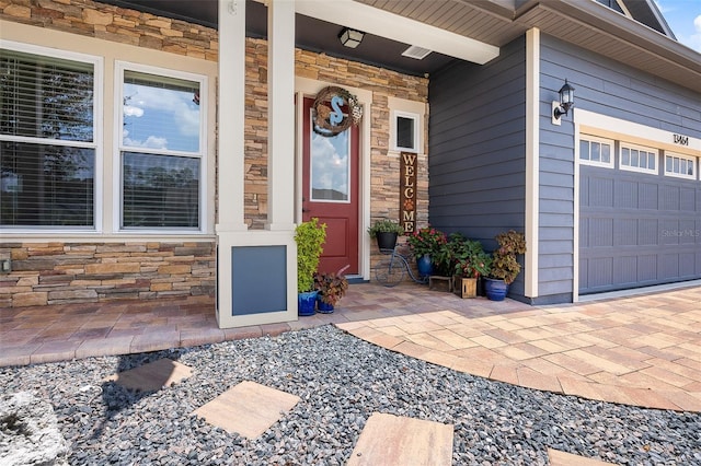 view of exterior entry with a garage