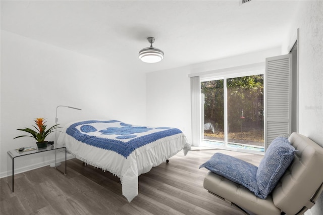 bedroom with light wood finished floors and baseboards