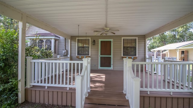 wooden terrace with a porch and ceiling fan