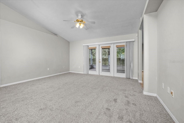 carpeted spare room featuring ceiling fan, french doors, and lofted ceiling