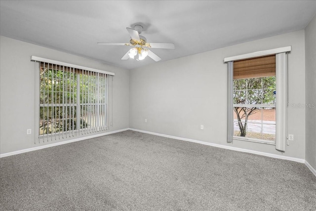 carpeted spare room with ceiling fan