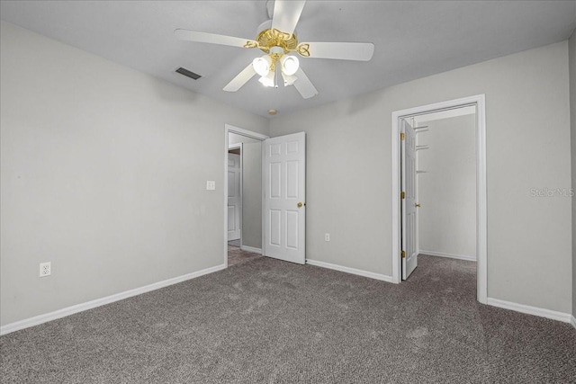 unfurnished bedroom with ceiling fan and dark colored carpet