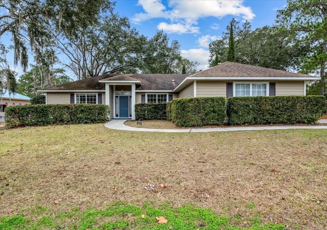 single story home with a front lawn