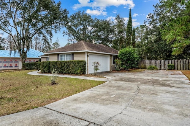 view of side of property featuring a garage and a lawn