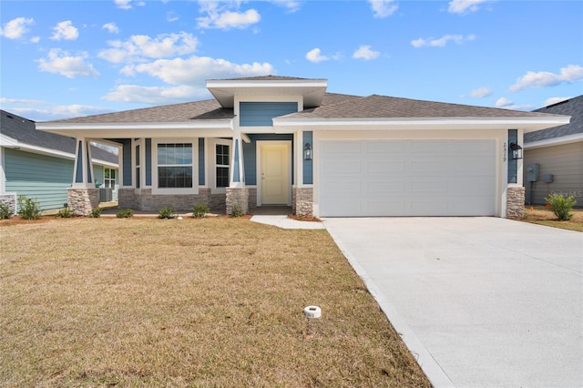 prairie-style home featuring a garage and a front lawn