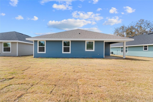 back of property featuring a lawn