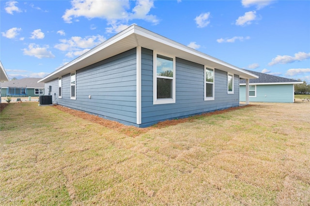 view of side of home featuring a yard and cooling unit