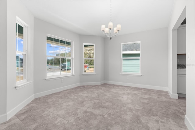 unfurnished dining area featuring a chandelier