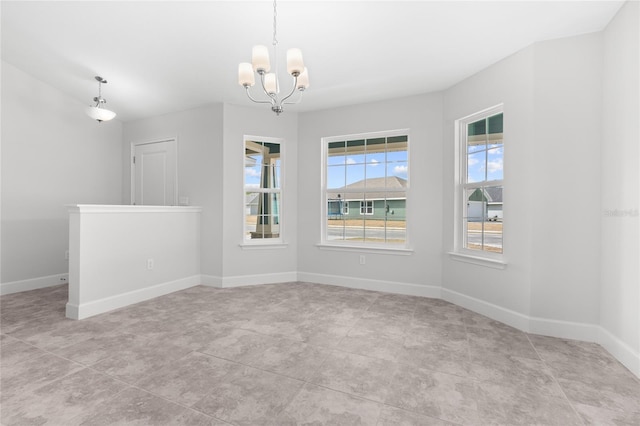 unfurnished room with a chandelier