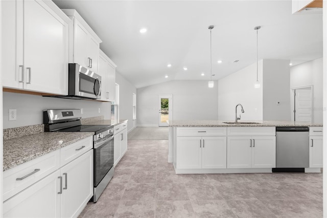 kitchen featuring white cabinetry, hanging light fixtures, appliances with stainless steel finishes, and vaulted ceiling