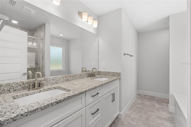 bathroom with vanity and a shower with door