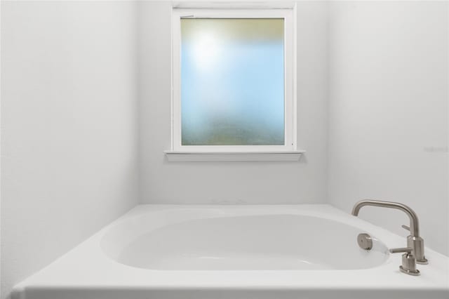 bathroom with a tub to relax in