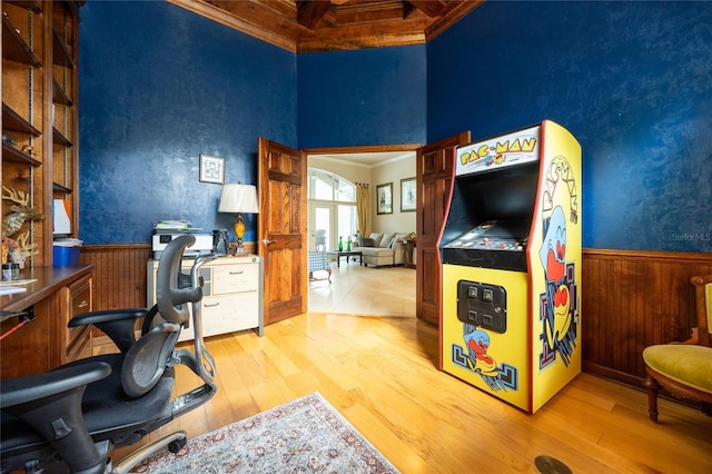 home office featuring beamed ceiling, light hardwood / wood-style floors, and ornamental molding