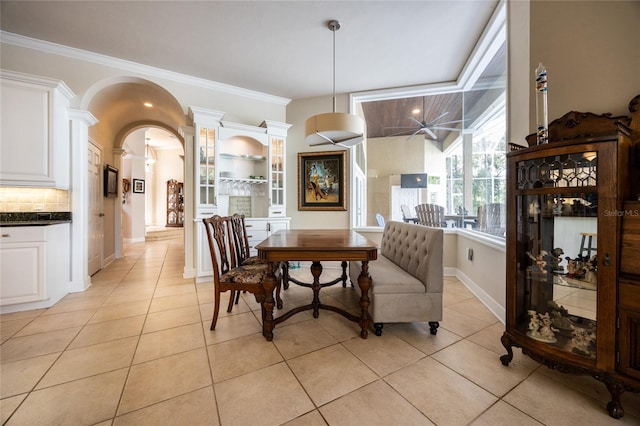 dining room featuring light tile patterned floors and crown molding