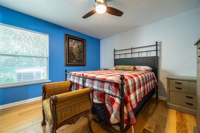 bedroom with ceiling fan and light wood-type flooring