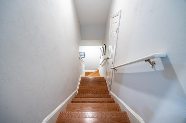 stairs featuring hardwood / wood-style floors