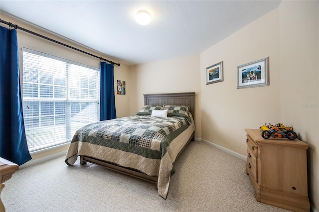 carpeted bedroom featuring multiple windows