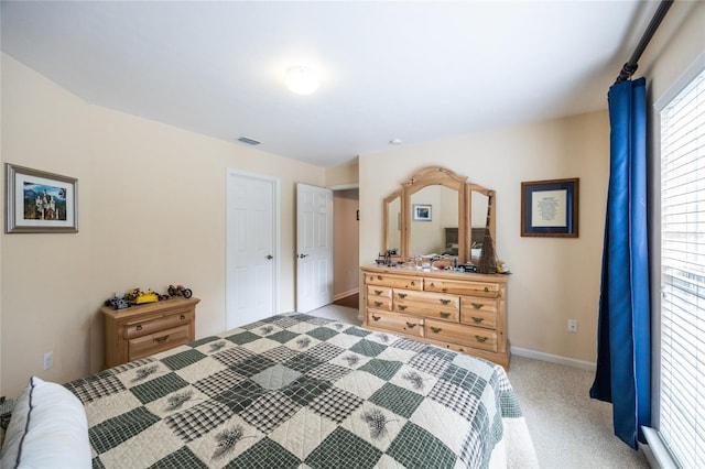 bedroom featuring light carpet