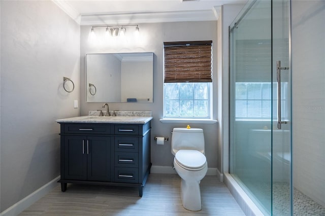 bathroom with vanity, toilet, a shower with door, and crown molding