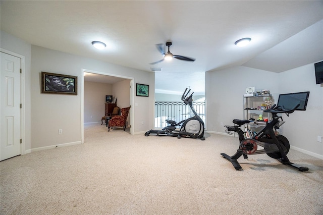 exercise room featuring carpet, vaulted ceiling, and ceiling fan