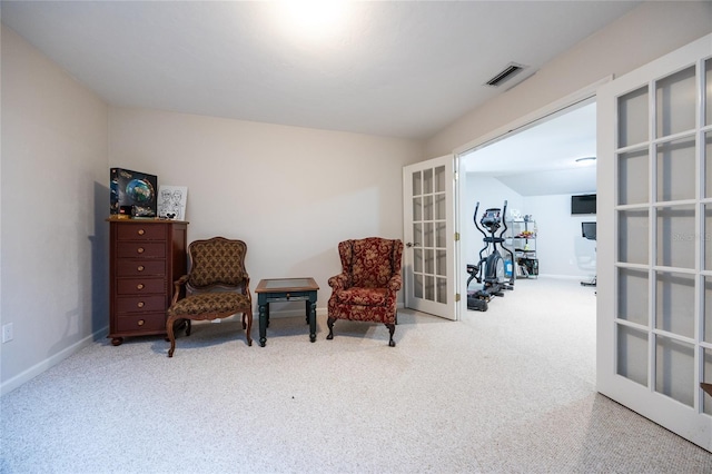 sitting room featuring carpet and french doors