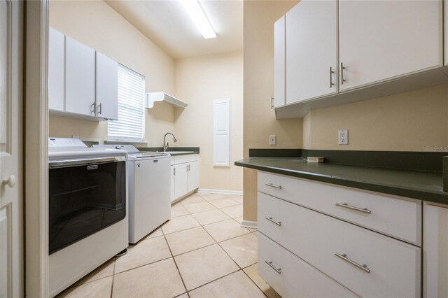 washroom featuring cabinets, sink, separate washer and dryer, and light tile patterned flooring