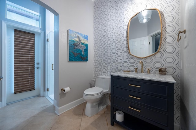 bathroom featuring tile patterned floors, vanity, and toilet