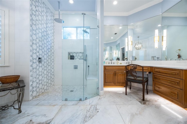 bathroom with vanity, an inviting chandelier, walk in shower, and ornamental molding