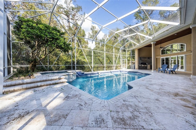 view of pool with ceiling fan, a lanai, and a patio