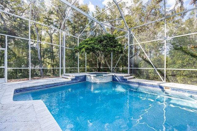 view of pool featuring a lanai and an in ground hot tub