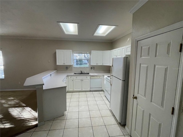 kitchen with white cabinets, kitchen peninsula, white appliances, light tile patterned floors, and ornamental molding