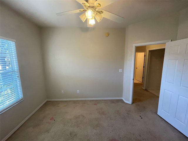 carpeted empty room featuring ceiling fan