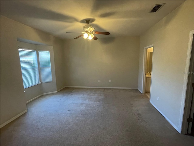 unfurnished room with ceiling fan and carpet floors