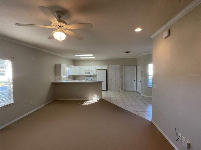 kitchen featuring kitchen peninsula, ornamental molding, white appliances, light tile patterned floors, and white cabinets