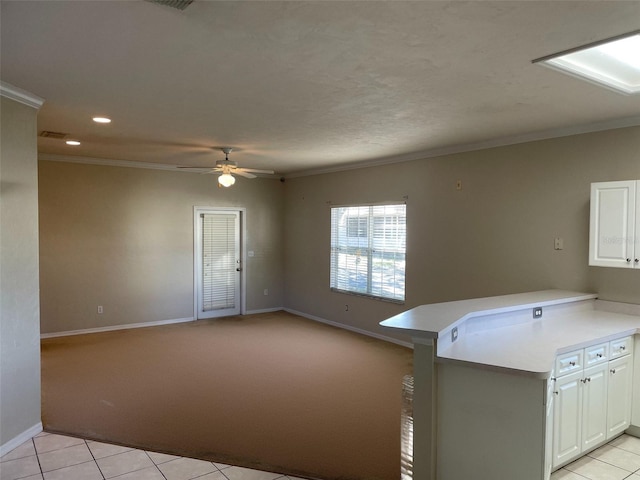 kitchen with white cabinetry, kitchen peninsula, and light tile patterned floors