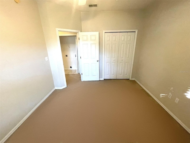 unfurnished bedroom featuring carpet flooring and a closet