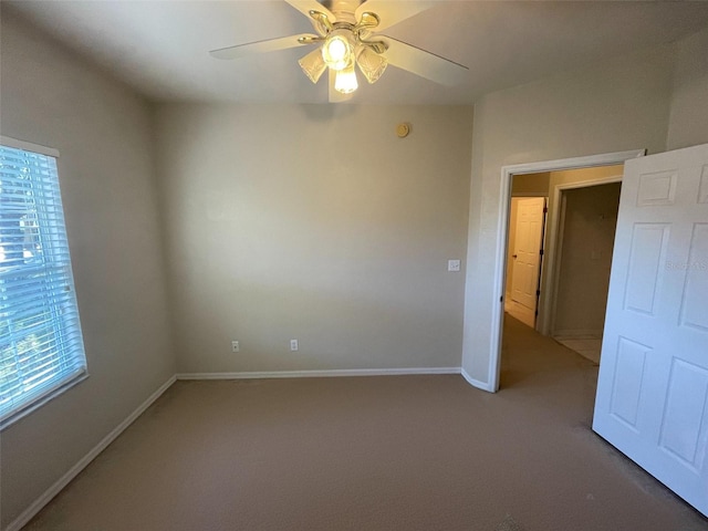 empty room featuring carpet, ceiling fan, and a healthy amount of sunlight