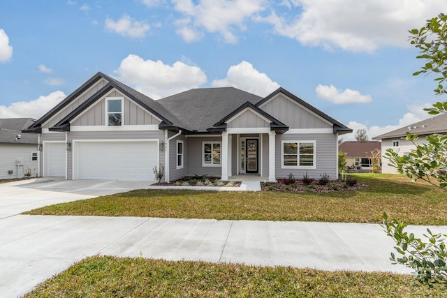 view of front of home with a front yard and a garage