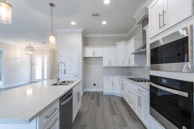 kitchen featuring white cabinets, hanging light fixtures, sink, and appliances with stainless steel finishes