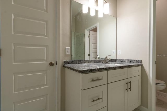 bathroom with a shower, vanity, and toilet