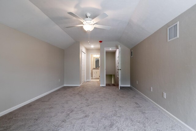 additional living space with ceiling fan, light carpet, and vaulted ceiling