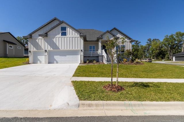 11828 NW 15th Rd, Gainesville, FL 32606 - view of front of property with concrete driveway, board and batten siding, a garage, and a front lawn