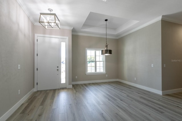 11828 NW 15th Rd, Gainesville, FL 32606 - entrance foyer with baseboards, an inviting chandelier, crown molding, a tray ceiling, and wood finished floors
